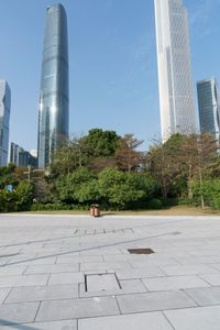 a group of people are walking around in the city on a sunny day with skyscrapers in the background