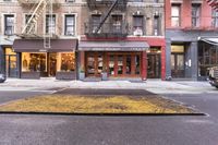 the sidewalk on the city side shows that people are walking outside of the shop front and shopping