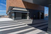 a picture of people walking on a sidewalk near an office building with some stairs in it