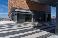 a picture of people walking on a sidewalk near an office building with some stairs in it