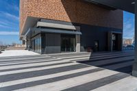 a picture of people walking on a sidewalk near an office building with some stairs in it