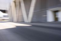 a person on a skate board rides down the street behind them are many other buildings