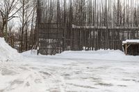 a person on skis riding down a snowy path next to a building in a snow covered area