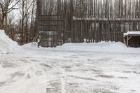 a person on skis riding down a snowy path next to a building in a snow covered area