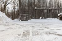 a person on skis riding down a snowy path next to a building in a snow covered area