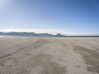 there is a person walking across the beach on a sunny day at the seaside shore