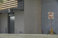 a fire hydrant stands in front of a building next to the street, with an outside area that is not crowded with people