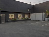 this is an empty, but tidy office building with dark paint and concrete walls and doors