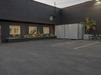 this is an empty, but tidy office building with dark paint and concrete walls and doors