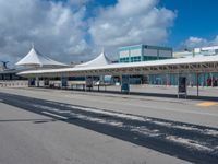 a white terminal with many windows, blue sky and clouds in the background of it