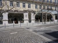 the street with no people is lined up with benches and tables outside of a restaurant