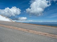 the man is at the top of a mountain on skis with mountains in the background