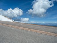 the man is at the top of a mountain on skis with mountains in the background