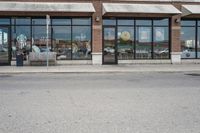 there is a pizza parlor front with a sign in the street for pizza hut store