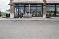 there is a pizza parlor front with a sign in the street for pizza hut store