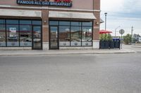 there is a pizza parlor front with a sign in the street for pizza hut store