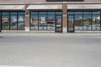 there is a pizza parlor front with a sign in the street for pizza hut store