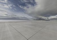 a plane is parked at an airport in the middle of a desert area with a few clouds