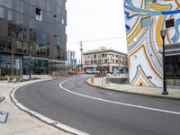 the corner of the city street has been painted in a bold swirly color scheme