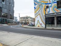 the cars are driving along a busy street with many buildings in front of them to show art work