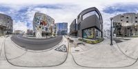 there is a fisheye view of the street in front of the shopping center, on the other side of the road