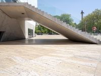 an empty wooden floor next to the entrance of a building with a big triangular roof