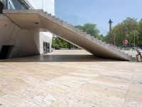 an empty wooden floor next to the entrance of a building with a big triangular roof