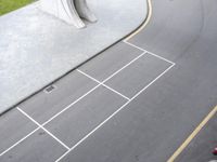 a paved road near the side of a street with a car driving by it,
