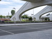 a building with some very interesting looking arches on it's side and cars in the street