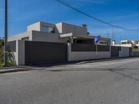 a street that has a fence around it in front of a building with a parking sign