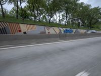 the view of the front entrance to a kmk store from a freeway window, with a building on one side