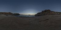 an 360 - pan picture taken at sunset on the beach with rocky formations in front