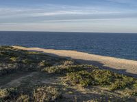 Portugal's Beach: Sand, Water, and Clear Skies