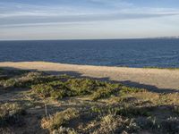 Portugal's Beach: Sand, Water, and Clear Skies