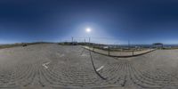 this is a large circular picture of a beach area that is made from stones and has a path on top of it