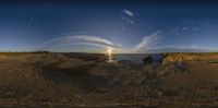 two people and their dog sitting at a beach watching a sunset with jets flying overhead