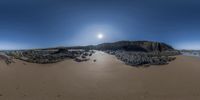 a panoramic view shows some very nice water and rocks and rocks on the beach