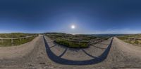 360 - view photograph of path and sand dunes near ocean with blue sky in the background