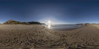 a fisheye panoramic picture with lots of sand and rocks on the side