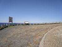 there is a bench that is sitting next to the ocean and a sign that says it is not possible