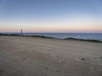 a view across the desert from the ocean at sunset and the end of the road