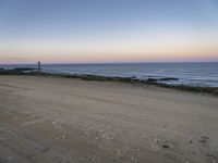 a view across the desert from the ocean at sunset and the end of the road