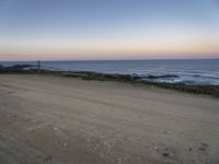 a view across the desert from the ocean at sunset and the end of the road