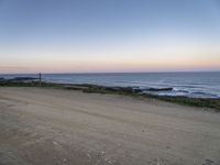 a view across the desert from the ocean at sunset and the end of the road