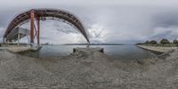 a 360 - view photo of a pier, including a man and a dog near the water