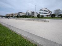 an empty city street with a bench in front of it in a commercial area for people