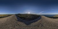 there is a 3d style view from below of a desert hill with water in the distance