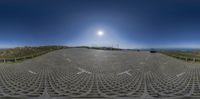 this is an 360 view of the parking lot near the road with cars driving on it