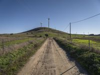 windmills rise above a hill in this rural area of the pacific area of california