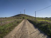 windmills rise above a hill in this rural area of the pacific area of california